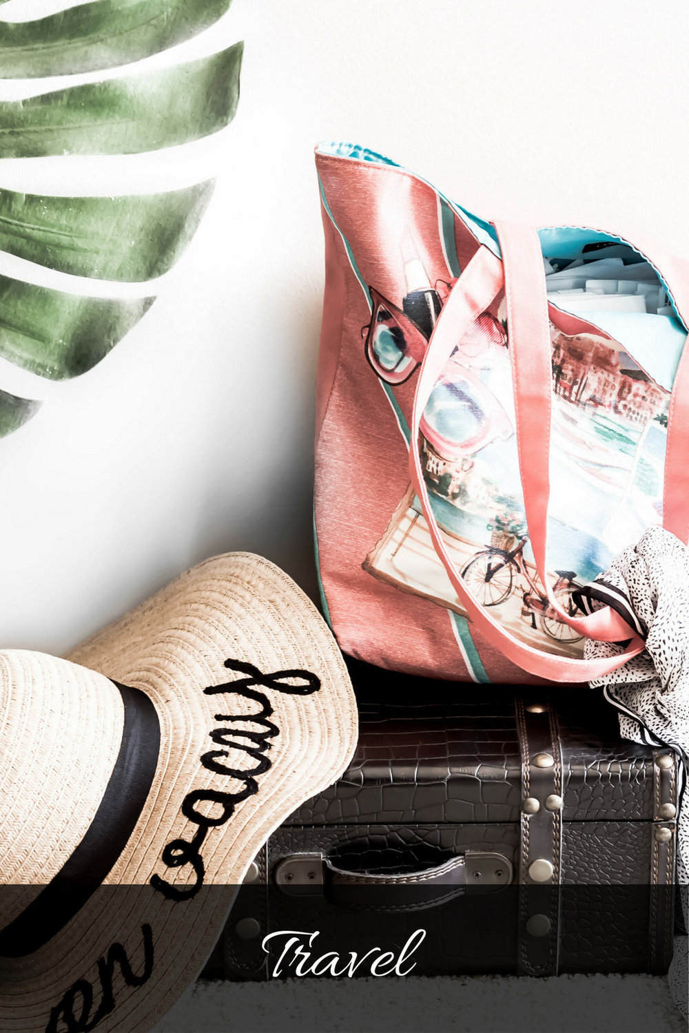 Travel suitcase with tote and straw hat and banana leaf.jpg